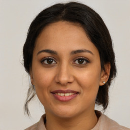 Joyful latino young-adult female with medium  brown hair and brown eyes