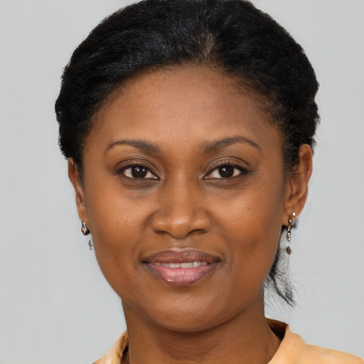 Joyful black adult female with short  black hair and brown eyes