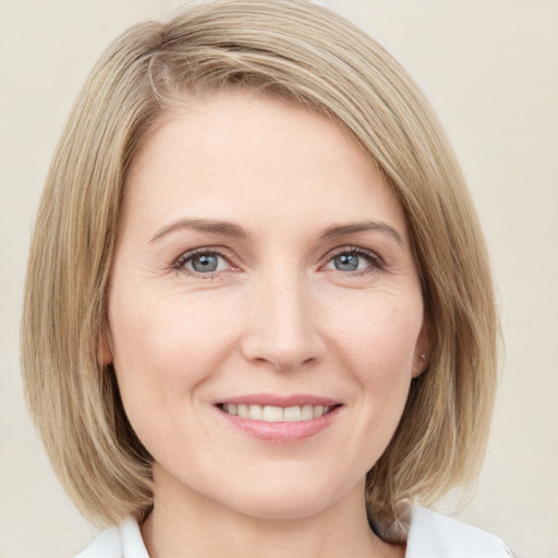 Joyful white young-adult female with medium  brown hair and blue eyes