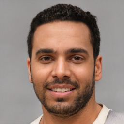 Joyful white young-adult male with short  black hair and brown eyes