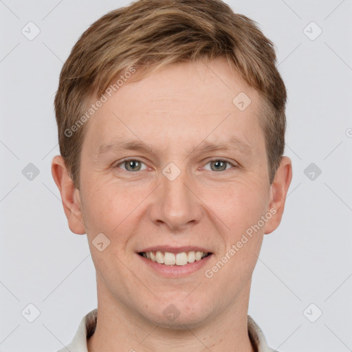 Joyful white adult male with short  brown hair and grey eyes