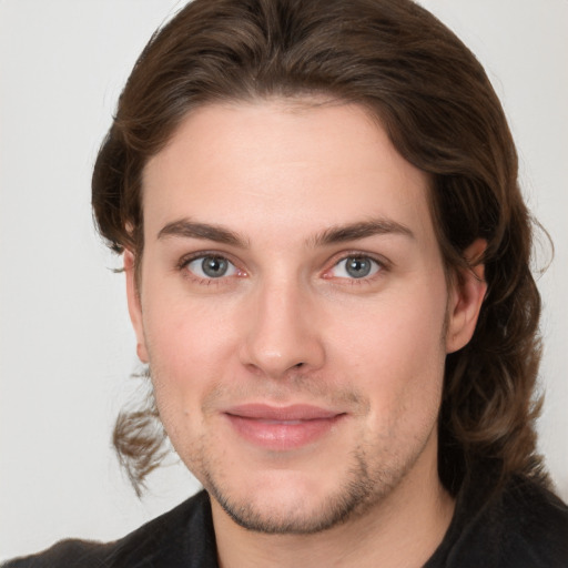 Joyful white young-adult male with medium  brown hair and brown eyes