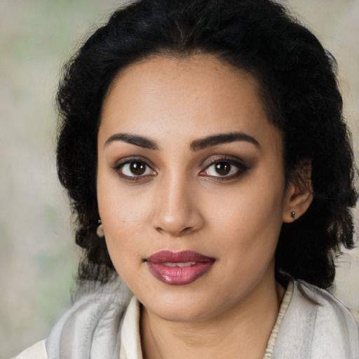 Joyful latino young-adult female with medium  black hair and brown eyes