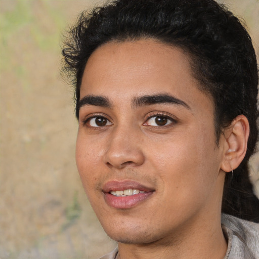 Joyful white young-adult male with short  black hair and brown eyes