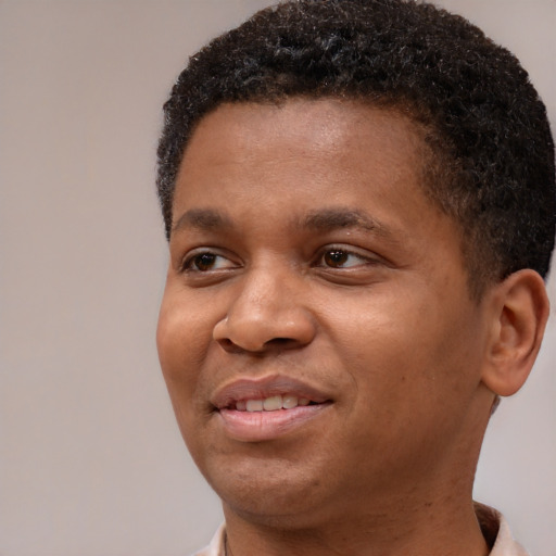 Joyful black young-adult male with short  brown hair and brown eyes