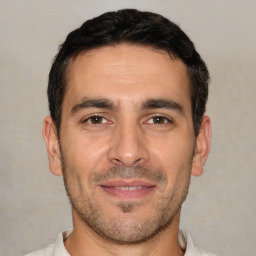 Joyful white adult male with short  black hair and brown eyes