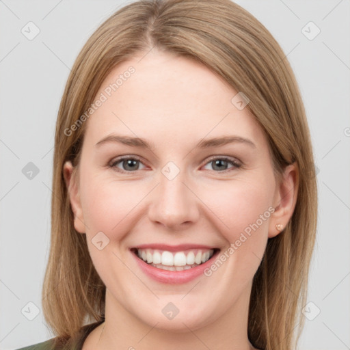 Joyful white young-adult female with long  brown hair and green eyes