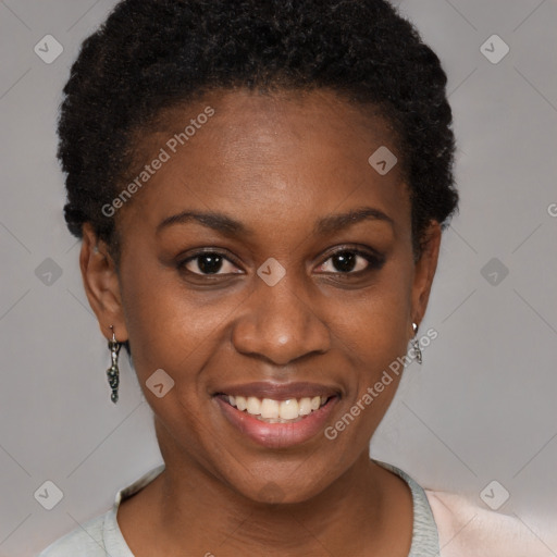 Joyful black young-adult female with short  black hair and brown eyes