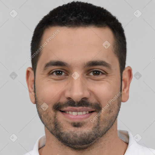 Joyful white young-adult male with short  black hair and brown eyes