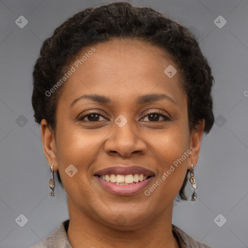 Joyful black adult female with short  brown hair and brown eyes