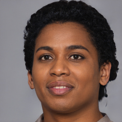 Joyful black young-adult female with short  black hair and brown eyes