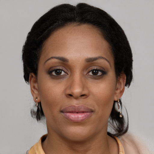 Joyful black young-adult female with medium  brown hair and brown eyes