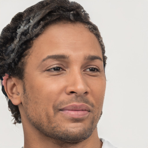 Joyful latino adult male with short  brown hair and brown eyes