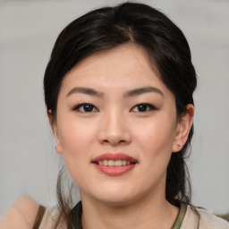 Joyful asian young-adult female with medium  brown hair and brown eyes