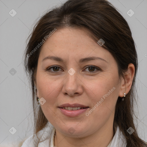 Joyful white adult female with medium  brown hair and brown eyes