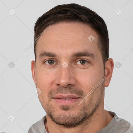 Joyful white adult male with short  brown hair and brown eyes