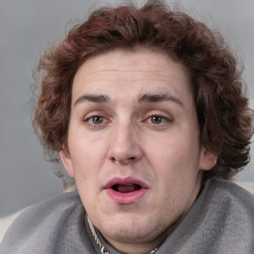 Joyful white adult male with medium  brown hair and blue eyes