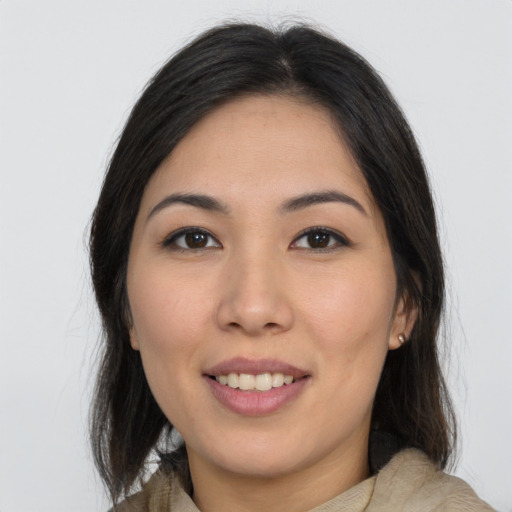 Joyful asian young-adult female with long  brown hair and brown eyes