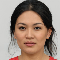 Joyful asian young-adult female with medium  brown hair and brown eyes