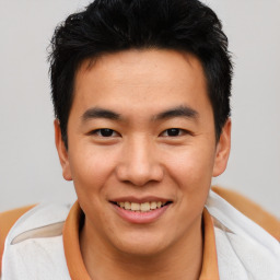 Joyful asian young-adult male with short  brown hair and brown eyes