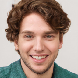 Joyful white young-adult male with short  brown hair and blue eyes