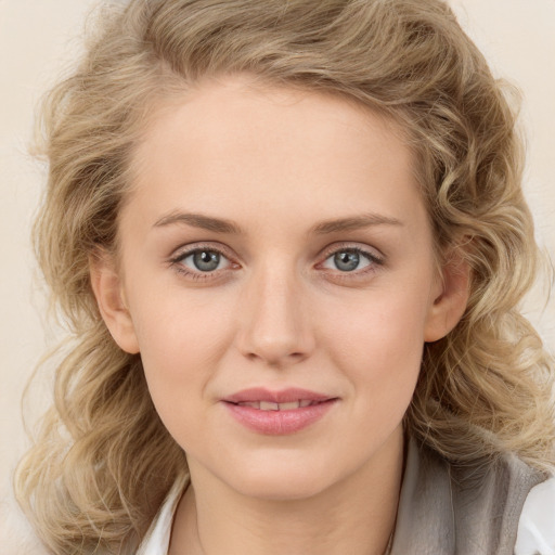 Joyful white young-adult female with medium  brown hair and blue eyes