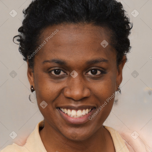 Joyful black young-adult female with short  brown hair and brown eyes