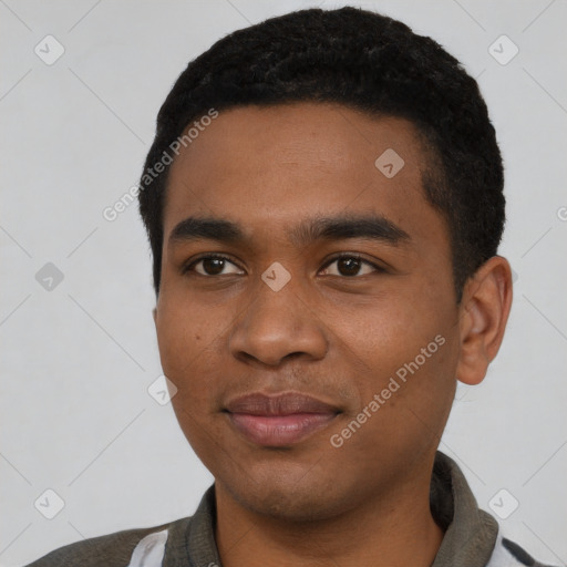 Joyful black young-adult male with short  black hair and brown eyes