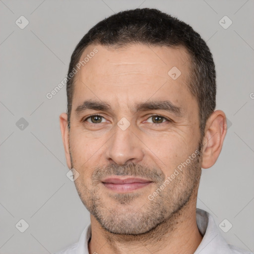 Joyful white adult male with short  black hair and brown eyes