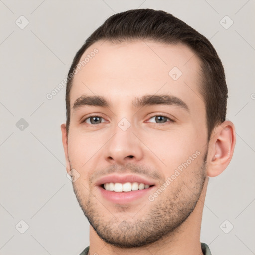 Joyful white young-adult male with short  brown hair and brown eyes