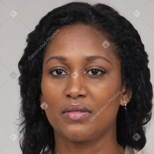 Joyful black young-adult female with long  black hair and brown eyes