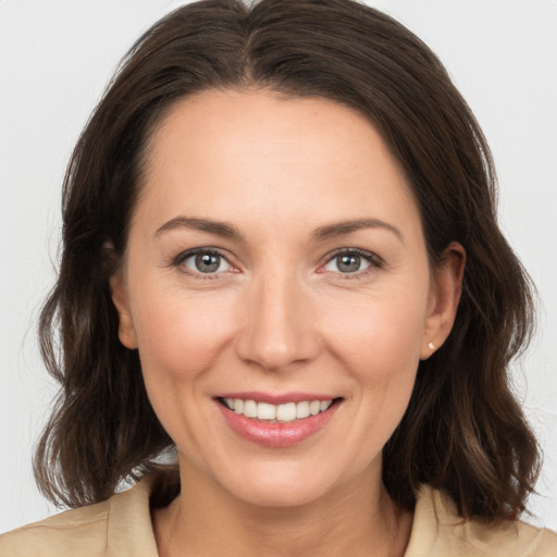 Joyful white adult female with medium  brown hair and brown eyes