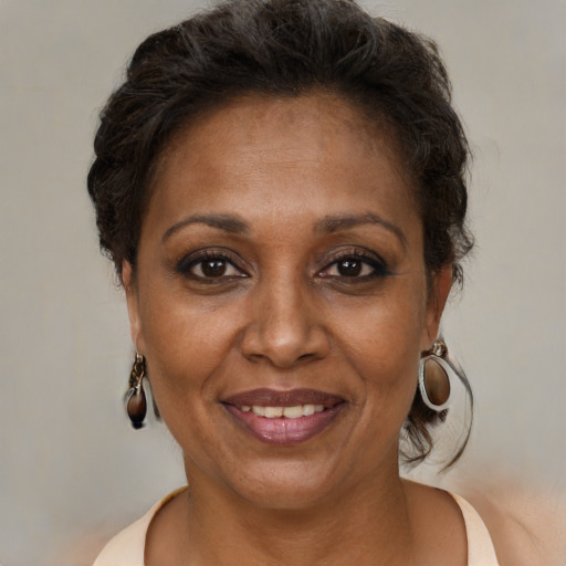 Joyful black adult female with short  brown hair and brown eyes