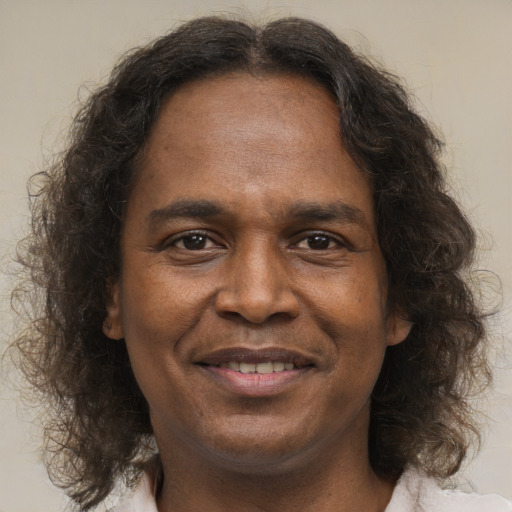 Joyful latino adult male with medium  brown hair and brown eyes