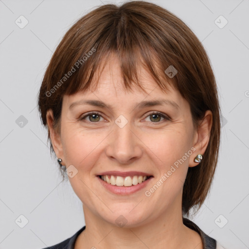 Joyful white adult female with medium  brown hair and grey eyes