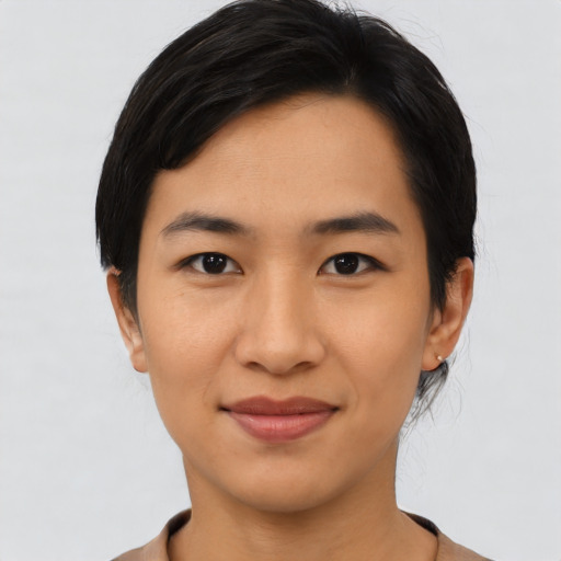 Joyful asian young-adult female with short  black hair and brown eyes