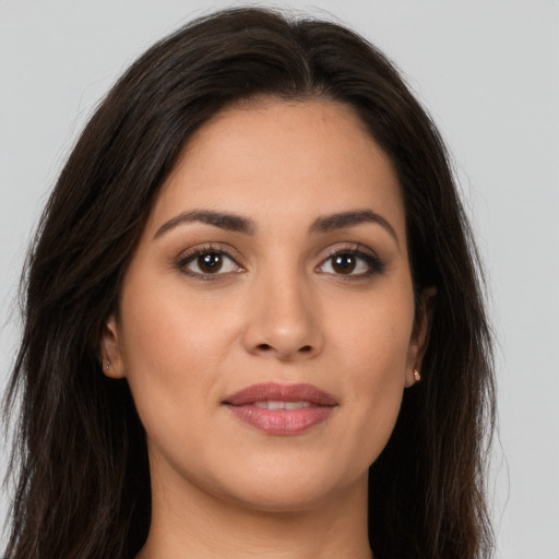 Joyful white young-adult female with long  brown hair and brown eyes