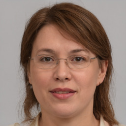 Joyful white adult female with medium  brown hair and grey eyes