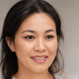 Joyful asian young-adult female with long  brown hair and brown eyes