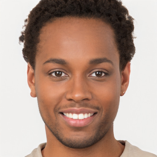 Joyful black young-adult male with short  brown hair and brown eyes