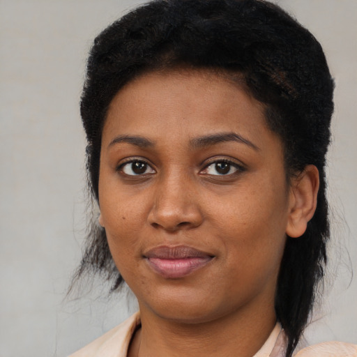 Joyful black young-adult female with medium  brown hair and brown eyes
