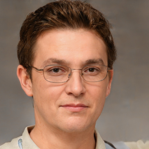 Joyful white adult male with short  brown hair and grey eyes