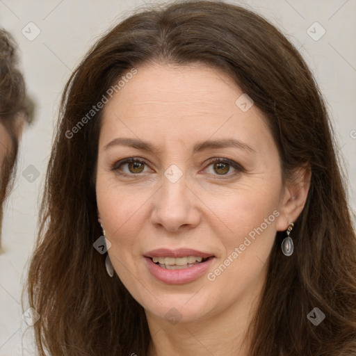 Joyful white adult female with long  brown hair and brown eyes