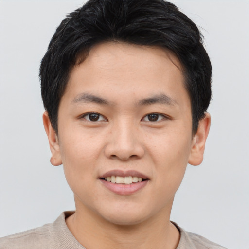 Joyful asian young-adult male with short  black hair and brown eyes