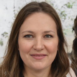 Joyful white adult female with long  brown hair and brown eyes