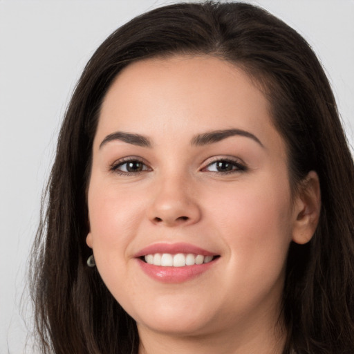 Joyful white young-adult female with long  brown hair and brown eyes