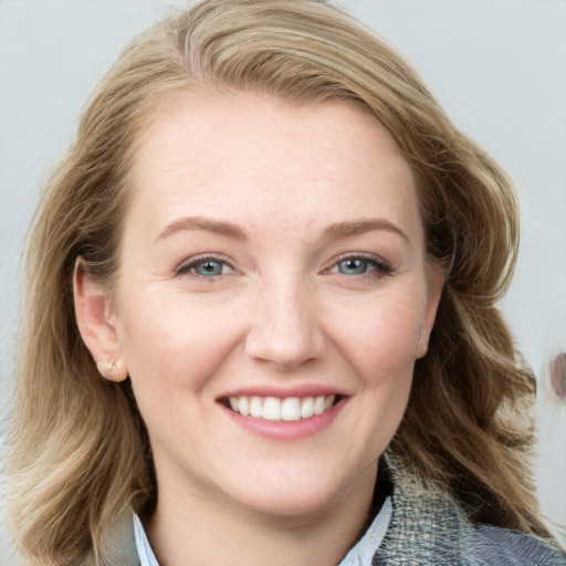 Joyful white young-adult female with medium  brown hair and blue eyes