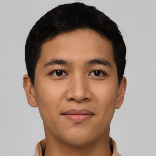 Joyful asian young-adult male with short  black hair and brown eyes