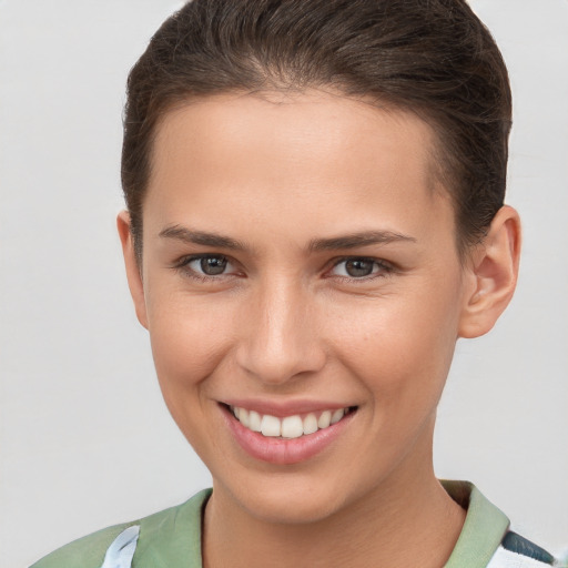 Joyful white young-adult female with short  brown hair and brown eyes