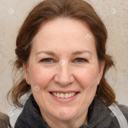 Joyful white adult female with medium  brown hair and grey eyes